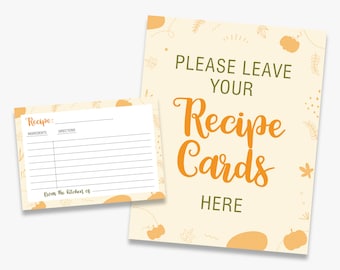 Pode incluir: Um conjunto de cartões de receitas e um letreiro com tema de outono. O letreiro diz "PLEASE LEAVE YOUR Recipe Cards HERE" em escrita laranja. O cartão de receita tem linhas para ingredientes e instruções.