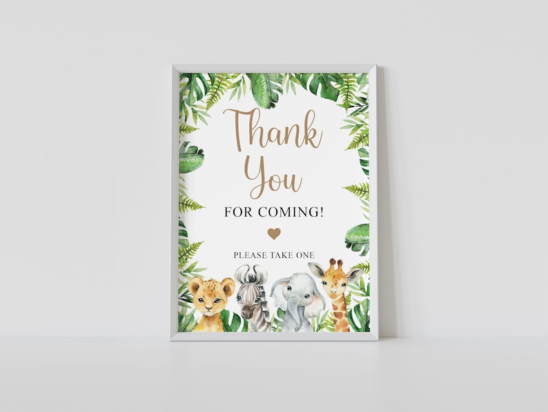 May include: A white framed sign with a green jungle border and the text "Thank You for Coming!" with a heart. The sign also has the text "Please Take One" and features a lion, zebra, elephant, and giraffe.