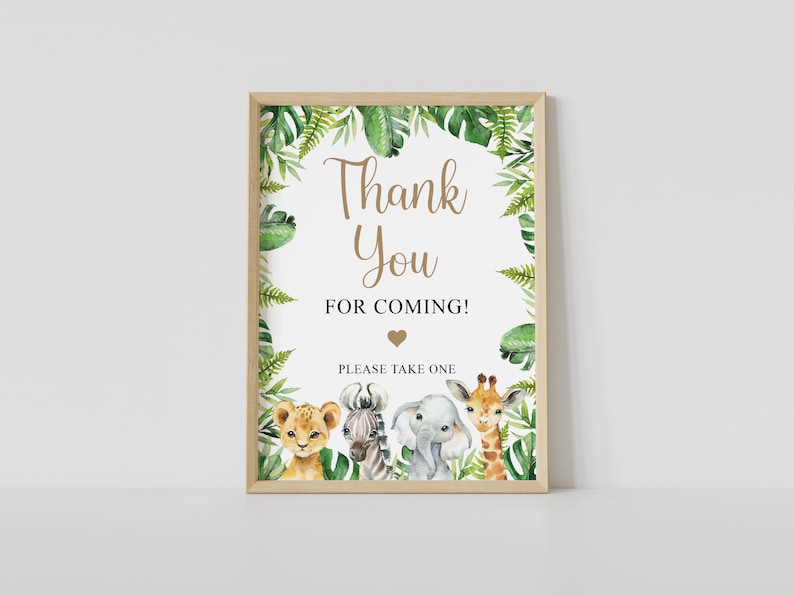 May include: A printable thank you sign with a jungle theme. The sign features a lion, zebra, elephant, and giraffe with green leaves and the text "Thank You for Coming! Please Take One".
