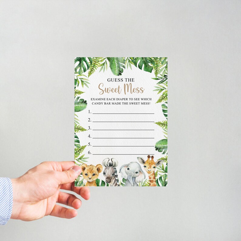 May include: A printable baby shower game card with a jungle theme. The card has a green leafy background with a gold title that says "Guess the Sweet Mess". The card has instructions to examine each diaper to see which candy bar made the sweet mess. There are six lines for guests to write their guesses.