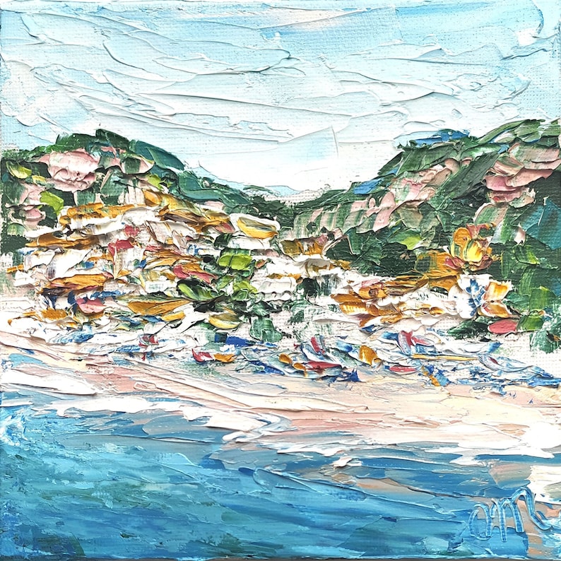 May include: A painting of a coastal scene with a blue ocean, white sandy beach, and green hills in the background. The hills are covered in white and yellow buildings, and there are boats in the water.