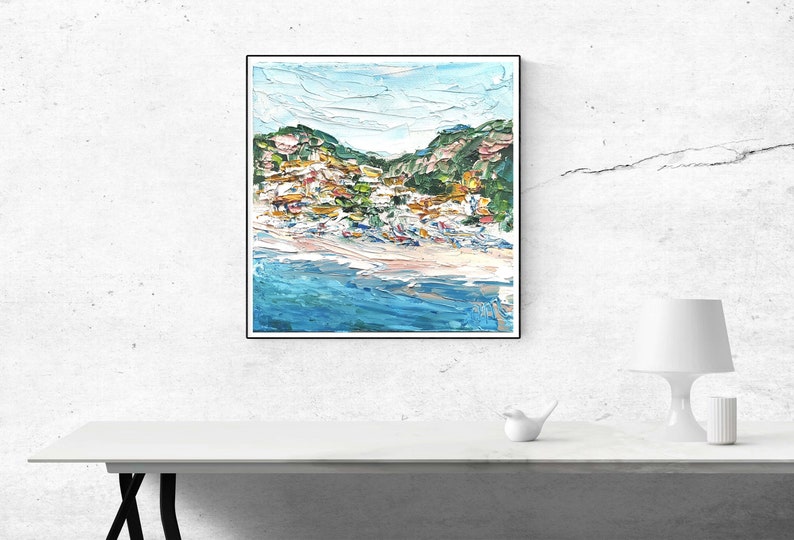May include: A painting of a coastal town with colorful buildings on a hillside overlooking a blue ocean. The painting is done in a loose, impressionistic style with visible brushstrokes.