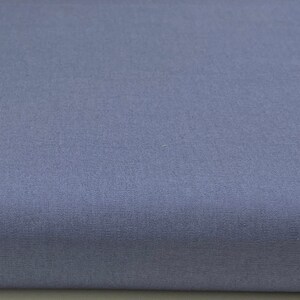 May include: A solid, light blue fabric swatch. The fabric has a smooth, even texture.