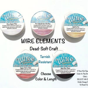 May include: Four spools of 22 gauge dead-soft craft wire in different colors: silver, rose gold, gold, and copper. Each spool is labeled "Wire Elements Dead-Soft Craft Wire Round" and includes the color, gauge, and length of the wire. The text "Tarnish Resistant" is also displayed.