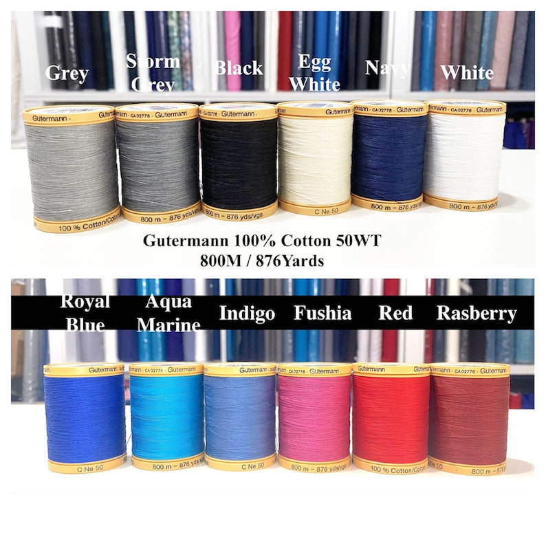 May include: Spools of Gutermann 100% cotton thread in various colors, including grey, storm grey, black, egg white, navy, white, royal blue, aqua marine, indigo, fuschia, red, and raspberry. Each spool is 800 meters (876 yards) long.