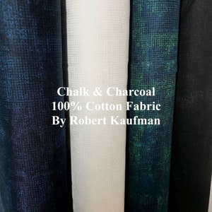 May include: Four rolls of 100% cotton fabric in black, white, green, and blue with a subtle textured pattern. The fabric is labeled "Chalk & Charcoal 100% Cotton Fabric By Robert Kaufman".
