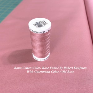 May include: A spool of Gutermann thread in the color Old Rose, next to a piece of Kona Cotton fabric in the color Rose. The text on the spool reads "Gutermann 21-2743 200 m - 274 yards".