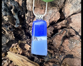 Glass fused pendant custom made by Jeanne. Colors are powder blue and periwinkle sparkling  blue with a textured bail.