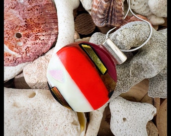Round circle glass pendant bright red,orange and cream with hints of  sparkling bronze and shimmering gold dichro glass.