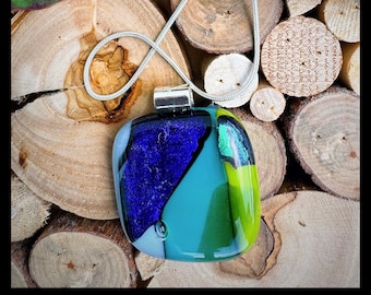 Glass fused pendant custom made by Jeanne. Colors are a variety of sparkling blues and greens with a dichroic essence.
