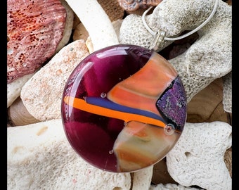 Round circle glass pendant tones of purples ,orange and cream with hints of  sparkling bronze and shimmering gold dichroic glass.