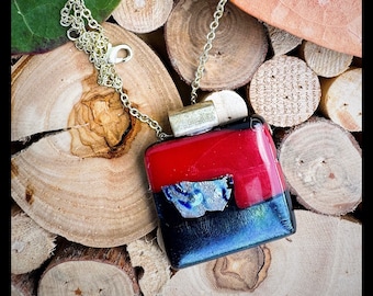 Glass fused pendant custom made by Jeanne. Colors are a variety of sparkling red and black with a dichroic essence.