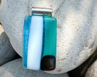 Glass fused pendant custom made by Jeanne. Colors are transparent blue, opal turquoise, soft white with a dichroic dark square.