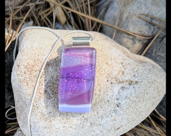 Glass pendant is custom made by Jeanne. Colors are a variety of sparkling purples with a dichroic essence.
