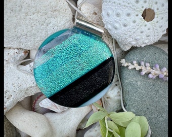 Round circle glass pendant bright turquoise and green dichroic glass with hints of  sparkling bronze and shimmering black.