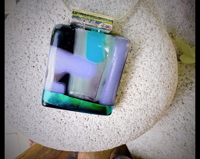 Featured listing image: Glass pendant is a long rectangular shape. Colors are orange, red, light blue and a touch of teal, gold and dichroic navy blue.