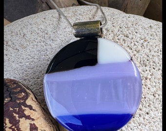 Round circle glass pendant with a medley of purple and blues hints of sparkle, white/black dark blue accent and shimmering iridescent glass.