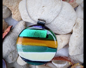 Striped circle glass pendant earthy greens and tones with dichroic blue with hints of sparkling bronze and shimmer.