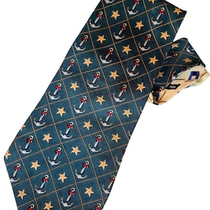May include: A teal necktie with a repeating pattern of white anchors with red accents and gold stars. The anchors are set within a grid of gold rope. The reverse side of the tie has a nautical design.