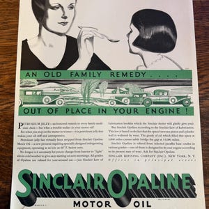 May include: Vintage advertisement for Sinclair Opaline Motor Oil. The image features stylized illustrations of women and classic cars. Text includes "An Old Family Remedy" and "Out of Place in Your Engine!"
