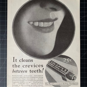 May include: An advertisement from Photoplay Magazine, June 1930, showing a smiling mouth. The ad promotes Colgate's Ribbon Dental Cream, with text highlighting cleaning between teeth. A tube of toothpaste is also shown.