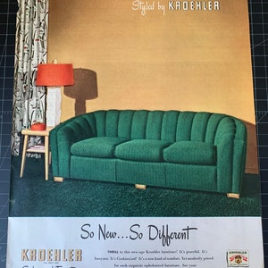 May include: Vintage advertisement for Kroehler furniture. The image features a green sofa with a ribbed design, a small side table with a red lamp, and patterned curtains. The text reads "Styled by KROEHLER" and "So New... So Different."