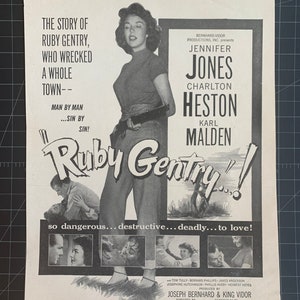 May include: Black and white movie poster for the film "Ruby Gentry" starring Jennifer Jones, Charlton Heston, and Karl Malden. The poster features a dramatic image of Jennifer Jones holding a gun, with the title of the film in large, bold letters.