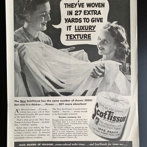 May include: A vintage black and white advert for Scott Tissue. The image shows two women holding up a large sheet of the tissue, with text promoting its luxury texture and absorbency. A roll of Scott Tissue is also displayed.
