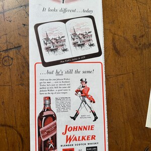 May include: Vintage advertisement for Johnnie Walker Blended Scotch Whisky. The ad features a bottle of Red Label whisky, a drawing of a man in a red coat, and the text "Johnnie Walker". The ad also includes the text "It looks different...today".
