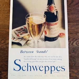 May include: Vintage advertisement for Schweppes Ginger Ale. The image features a glass of the beverage, a bottle, and playing cards. Text includes "Between 'hands'" and "Schweppes". The ad is from The Illustrated London News.