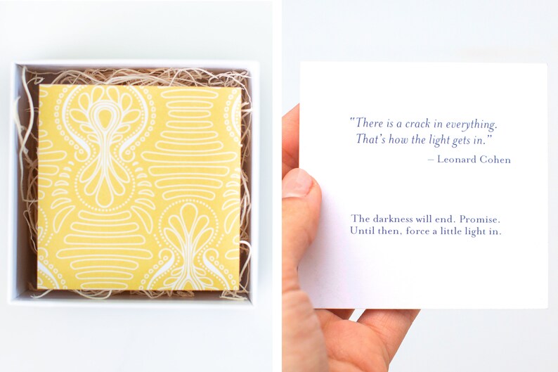 May include: A yellow and white patterned card with a quote by Leonard Cohen: "There is a crack in everything. That's how the light gets in." - Leonard Cohen. The card also includes the text: "The darkness will end. Promise. Until then, force a little light in."