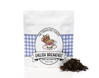 May include: A white pouch with a blue and white checkered pattern. The pouch has a logo that says "The Traveling Teapot" with a crown and a teacup with a Union Jack design. The text "English Breakfast" is written in a banner below the logo. The pouch contains loose leaf black tea. The text "Loose Leaf Black Tea" and "Net Wt. 1 oz. (28g)" is printed on the pouch.