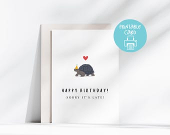 May include: Printable birthday card featuring a cartoon tortoise wearing a party hat and carrying a red heart. The card reads "Happy Birthday! Sorry it's late!"