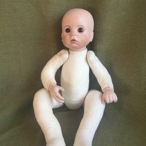 Gumdrop, a Boots Tyner doll.  Dress as boy or girl.  This cute baby is a porcelain bisque head with a cloth body. 17 inch doll.