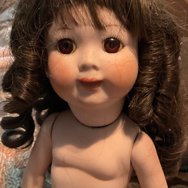 Googly doll 14 inch made in 1979 by Joy.  Brown glass eyes,   Brown curly wig.  Undressed.  Love her!