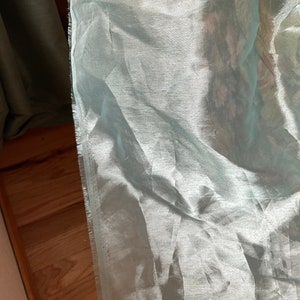 Turquoise see through see through material.  44 inches by 56 inches. Wrinkles are not part of fabric.