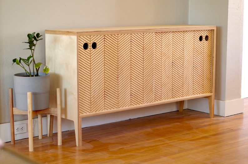 Modern scandinavian sideboard with two sliding doors on a hardwood floor