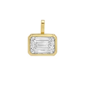 May include: A rectangular pendant featuring a clear, faceted emerald-cut gemstone set in a polished yellow gold bezel. The pendant includes a vertical gold bail at the top, designed for attachment to a chain, showcasing a clean, metallic finish.