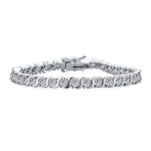 May include: A silver tennis bracelet with a row of sparkling round stones set in a wavy pattern.
