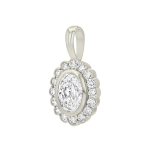 May include: A silver-toned pendant featuring a central oval-cut clear gemstone surrounded by a halo of twelve small round-cut clear stones. The pendant includes a smooth, polished bail at the top for attachment to a chain or necklace.