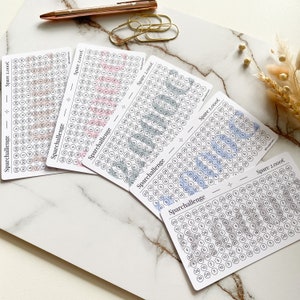 May include: Five printable cards with a light gray background and black text. Each card has a grid of circles with different colored stripes. The text on the cards reads "Sparchallenge" and "Spare 2,000&euro;".