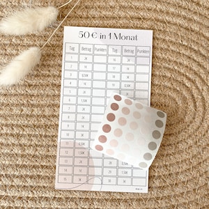 May include: A printable chart for tracking a 50 euro budget over a month. The chart is divided into 30 days, with columns for the day, amount, and points. The chart is printed on white paper with a light brown background.