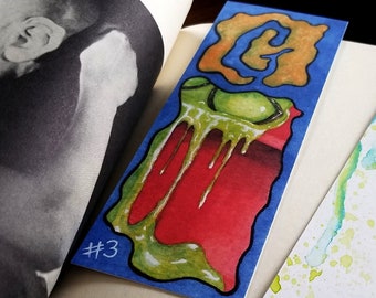 Bookmark illustrated with watercolor and ink based on horror book about a slimy monster that gave me goosebumps