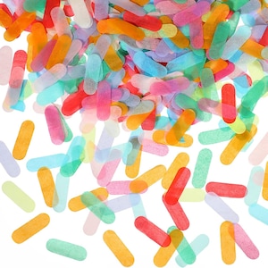 Puede incluir: Una dispersión de confeti colorido en forma de óvalos alargados. El confeti está hecho de papel de seda y está en tonos de rosa, azul, verde, amarillo y naranja.