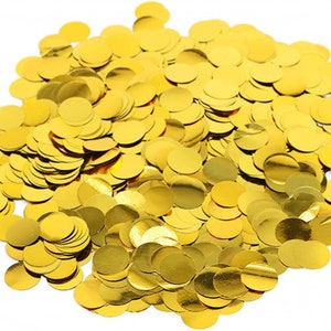 May include: A pile of gold confetti circles. The confetti is made of a shiny, metallic material.