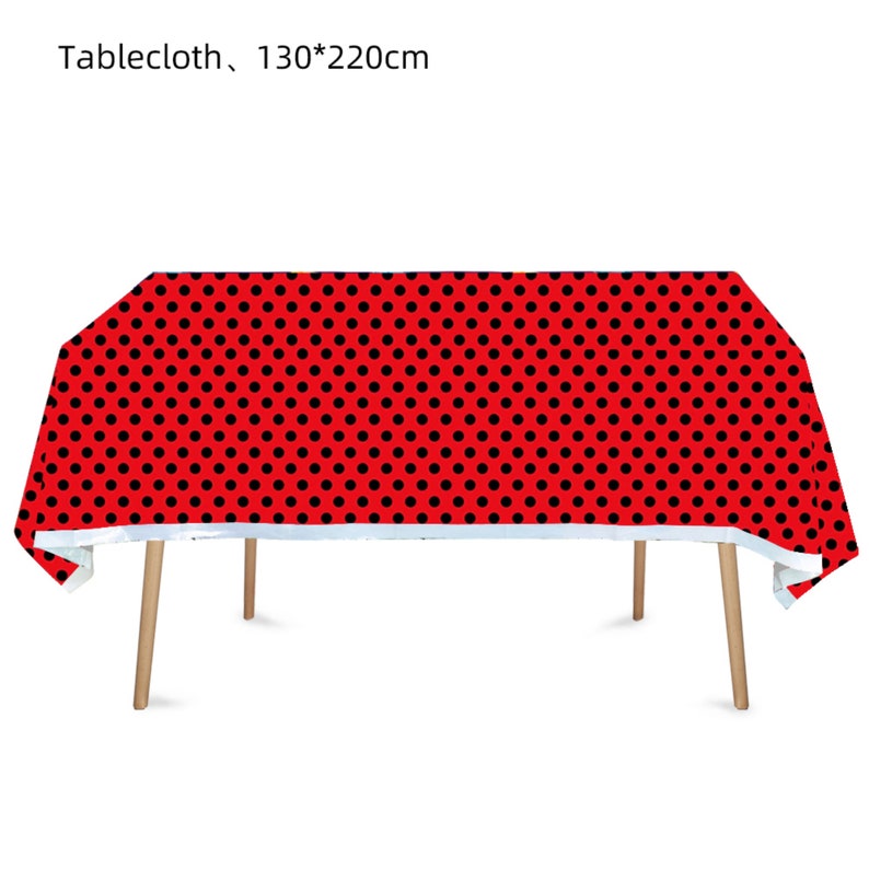 May include: Red tablecloth with black polka dots. Tablecloth measures 130 by 220 centimeters.