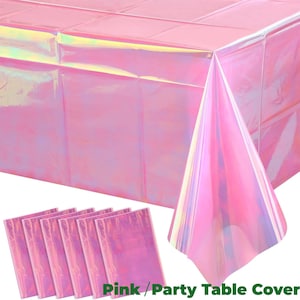 Könnte beinhalten: Rosa Party-Tischdecke und passende Tischsets. Die Tischdecke und die Tischsets haben ein schillerndes Finish, das eine Reihe von Farben reflektiert. Der Text "Pink / Party Table Cover" ist unten rechts sichtbar.