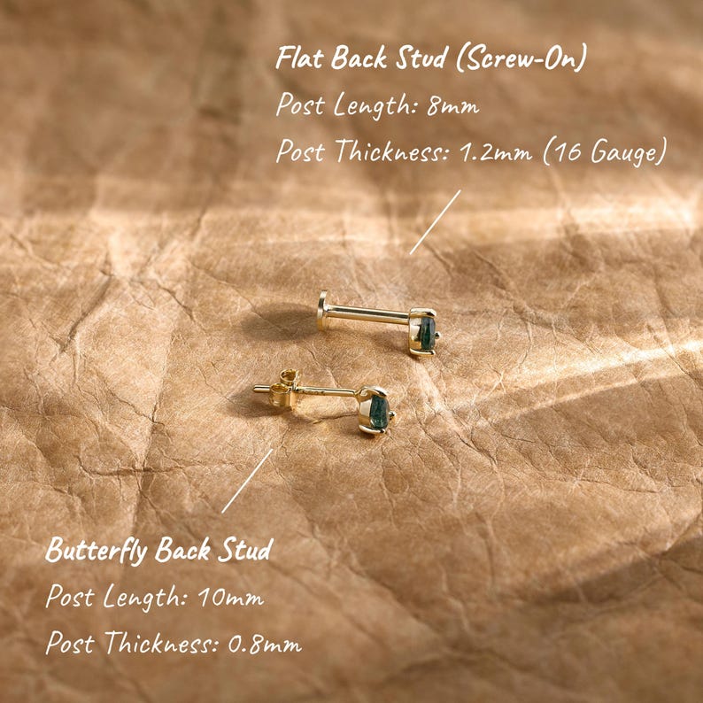 May include: Two gold-tone stud earrings with dark green pear-shaped stones. One is a flat back screw-on stud with an 8mm post length and 1.2mm thickness. The other is a butterfly back stud with a 10mm post length and 0.8mm thickness.