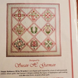 May include: A quilt pattern titled "Simply Baltimore" featuring a detailed design with red, green, and white floral and geometric patterns. The quilt measures 90 by 90 inches and is designed by Susan H. Garman.