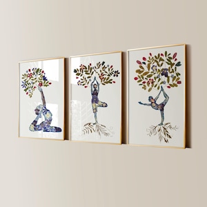 May include: Three framed wall art prints featuring figures in yoga poses. Each figure is composed of pressed flowers and leaves, with foliage forming a tree-like canopy above. The frames are thin and gold, displaying white backgrounds.